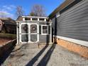 Gray storage shed with white trim, located in the backyard at 7535 Rabbit Cir, Denver, NC 28037