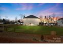 Spacious backyard with a wooden fence, green grass, and a single story home at 821 Bethesda Rd, Statesville, NC 28677