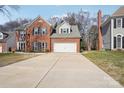 Two-story brick home with a two-car garage and a long driveway at 8720 Tamarron Dr, Charlotte, NC 28277