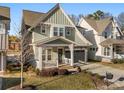 Attractive two-story home with a front porch, neatly landscaped yard, and a two-car garage at 907 Millbrook Rd, Charlotte, NC 28211