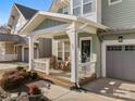 Inviting front porch with rocking chairs, adding character to this well-maintained home at 907 Millbrook Rd, Charlotte, NC 28211