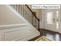 Elegant entryway with hardwood floors, wainscoting, and a staircase at 1033 Merganser Way, Indian Trail, NC 28079