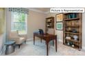 Bright home office features built-in shelving and a large window at 1033 Merganser Way, Indian Trail, NC 28079
