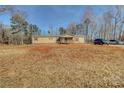 Tan mobile home with a large yard and covered porch at 1301 Brandy Ln # 7, Shelby, NC 28152