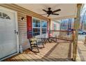 Two rocking chairs and a side table on a wooden porch at 1301 Brandy Ln # 7, Shelby, NC 28152