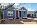 Blue craftsman style home with red door and a well-maintained lawn at 140 3Rd Se Ave, Hickory, NC 28602
