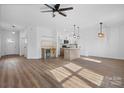 Open concept living space with kitchen island and hardwood floors at 140 3Rd Se Ave, Hickory, NC 28602