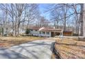 Long driveway leading to a charming home with a covered carport and an additional storage shed at 170 Woodcrest Rd, Mooresville, NC 28115