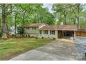 Charming split-level home featuring a well-manicured lawn, painted brick, and an attached carport at 170 Woodcrest Rd, Mooresville, NC 28115
