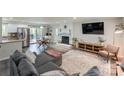 Bright, open-concept living area featuring modern furnishings, a cozy fireplace, and access to the kitchen at 170 Woodcrest Rd, Mooresville, NC 28115