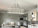 Bright living room featuring a stylish chandelier, couch, and kitchen view at 211 Brooklyn Ave, Lancaster, SC 29720