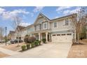 Charming two-story home with attached two car garage and manicured front lawn at 2201 Bluebell Way, Tega Cay, SC 29708