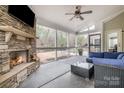 Screened porch with stone fireplace, ceiling fan, and outdoor seating area at 2201 Bluebell Way, Tega Cay, SC 29708