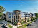 Modern apartment building with ample parking and landscaped grounds at 2401 Euclid Ave # 110, Charlotte, NC 28203