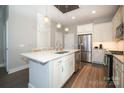 Modern kitchen with white cabinets, stainless steel appliances, and quartz countertops at 2401 Euclid Ave # 110, Charlotte, NC 28203