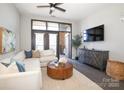 Spacious living room featuring a sectional sofa, hardwood floors, and access to a balcony at 2401 Euclid Ave # 110, Charlotte, NC 28203
