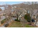Aerial view of the home with a lakeside setting and mature trees at 2498 Smith Harbour Dr, Denver, NC 28037