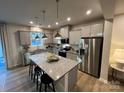 Modern kitchen featuring a granite countertop island with stainless steel appliances and gray cabinets at 276 Laura Elizabeth Ln, Clover, SC 29710