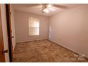 Well-lit bedroom featuring neutral walls, carpet flooring, and a large window with blinds at 3581 Thompson St, Newton, NC 28658