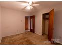 Bedroom with a ceiling fan, closet, and paneled doors, perfect for a cozy retreat at 3581 Thompson St, Newton, NC 28658