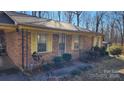 Brick ranch house with yellow shutters, front porch, and landscaping at 3581 Thompson St, Newton, NC 28658