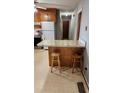 Kitchen features wood cabinets, a breakfast bar, and a floral countertop at 3581 Thompson St, Newton, NC 28658