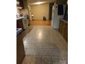 Simple kitchen with tiled floor, white appliances, and adjacent dining area at 372 Forest Hollow Dr, Statesville, NC 28677