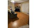 Living room with laminate floors, stone fireplace, and large window at 372 Forest Hollow Dr, Statesville, NC 28677