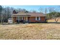 Brick ranch home with a brown roof, shutters, and a covered porch at 4539 Sapp Rd, Kannapolis, NC 28083