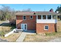 Rear view of brick home with sunroom, deck, and patio at 4539 Sapp Rd, Kannapolis, NC 28083