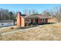 Brick ranch home with a brown roof, shutters, and a covered porch at 4539 Sapp Rd, Kannapolis, NC 28083