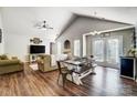 Open living room with vaulted ceiling, hardwood floors, and a farmhouse table at 5113 Park Place Dr, Dallas, NC 28034
