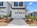 Inviting two-story home with a one-car garage, fresh landscaping, and a welcoming facade at 604 Cassidy Ct, Clover, SC 29710