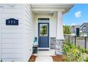 Charming front porch with stone accents, a stylish blue door, and a 'welcome' mat at 604 Cassidy Ct, Clover, SC 29710