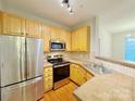Well-equipped kitchen featuring light wood cabinets and stainless steel appliances at 6726 Mallard Park Dr, Charlotte, NC 28262