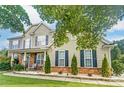 Beautiful two-story home showcasing stone details, dark shutters, and a well-kept front yard at 712 Springwood Dr, Waxhaw, NC 28173