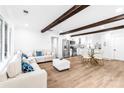 Open concept living space with exposed beams, modern kitchen, and light flooring at 809 Miller St, Gastonia, NC 28052