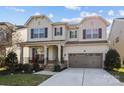 Charming two-story home featuring a covered front porch and a two-car garage at 840 Pecan Tree Ln, Fort Mill, SC 29715