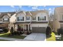 Charming two-story home featuring a covered front porch and a two-car garage at 840 Pecan Tree Ln, Fort Mill, SC 29715