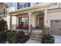 Welcoming front porch with seating area and elegant stone-accented entryway at 840 Pecan Tree Ln, Fort Mill, SC 29715