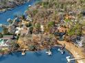 Waterfront homes feature private docks and boat slips, surrounded by mature trees at 1077 Gauguin Ln, Tega Cay, SC 29708