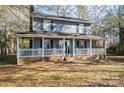 Front view of a charming two-story house with a large porch at 1316 Neal Hawkins Rd, Gastonia, NC 28056