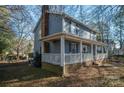 Gray house with a wraparound porch, showcasing the side view at 1316 Neal Hawkins Rd, Gastonia, NC 28056