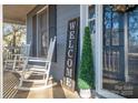 Relaxing front porch with rocking chairs and welcome decor at 1316 Neal Hawkins Rd, Gastonia, NC 28056