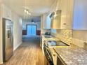 Modern kitchen with granite countertops and stainless steel appliances at 1618 4Th St, Salisbury, NC 28144