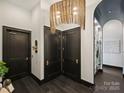 Modern hallway with dark doors and unique lighting at 19329 Watermark Dr # 261/262, Cornelius, NC 28031