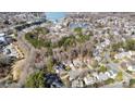 Aerial view of a neighborhood surrounded by trees and a lake, highlighting the community and location at 19600 Valiant Way, Cornelius, NC 28031