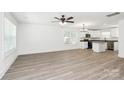 Bright, spacious living room featuring modern ceiling fan and stylish, light-colored flooring at 204 N Yadkin Ave, Spencer, NC 28150