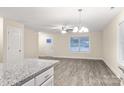 Bright living room featuring hardwood floors, neutral walls, and a modern chandelier at 204 N Yadkin Ave, Spencer, NC 28150