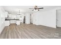 Open floor plan with modern, light-colored flooring connecting the living room and kitchen at 204 N Yadkin Ave, Spencer, NC 28150